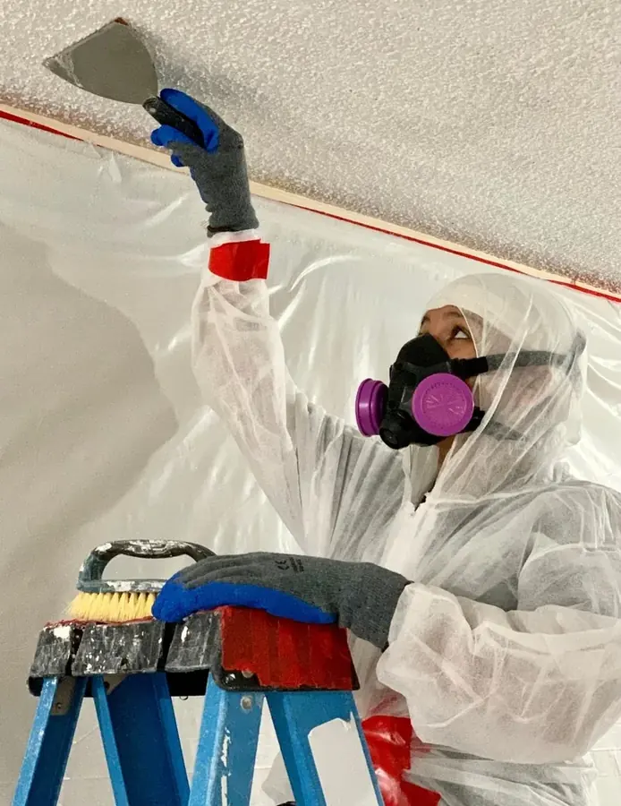 Water-stained ceiling being opened up inside a St. Louis home