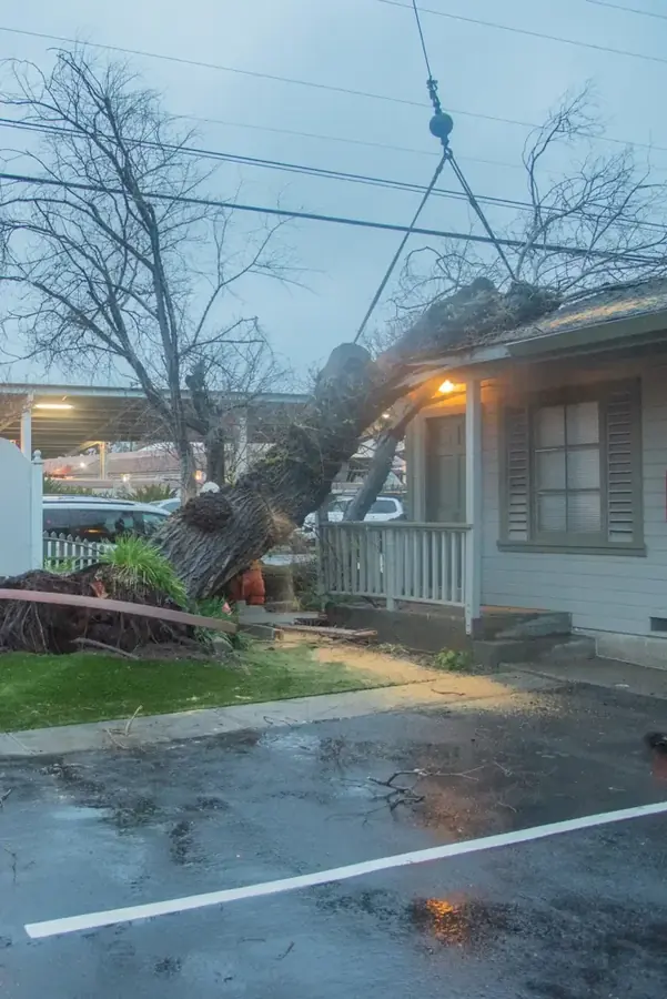 Ruptured water heater leaking across a St. Louis basement utility floor